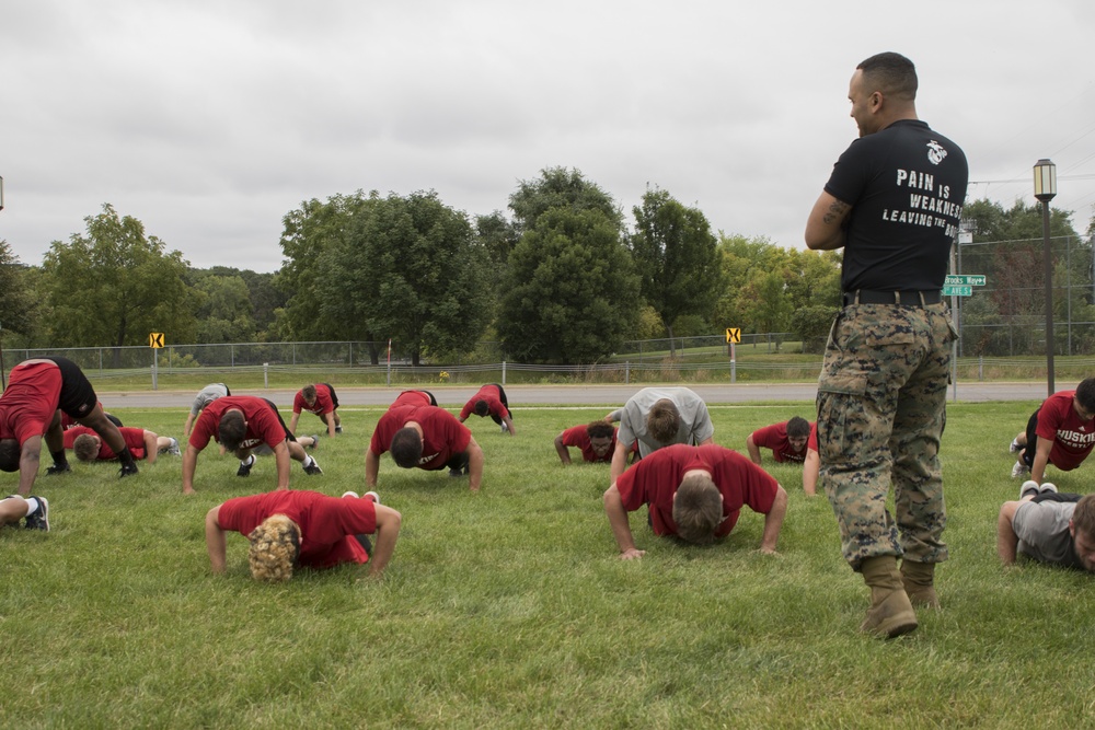 Digging deep; Marines train St. Cloud Wrestling Team to strive for greatness