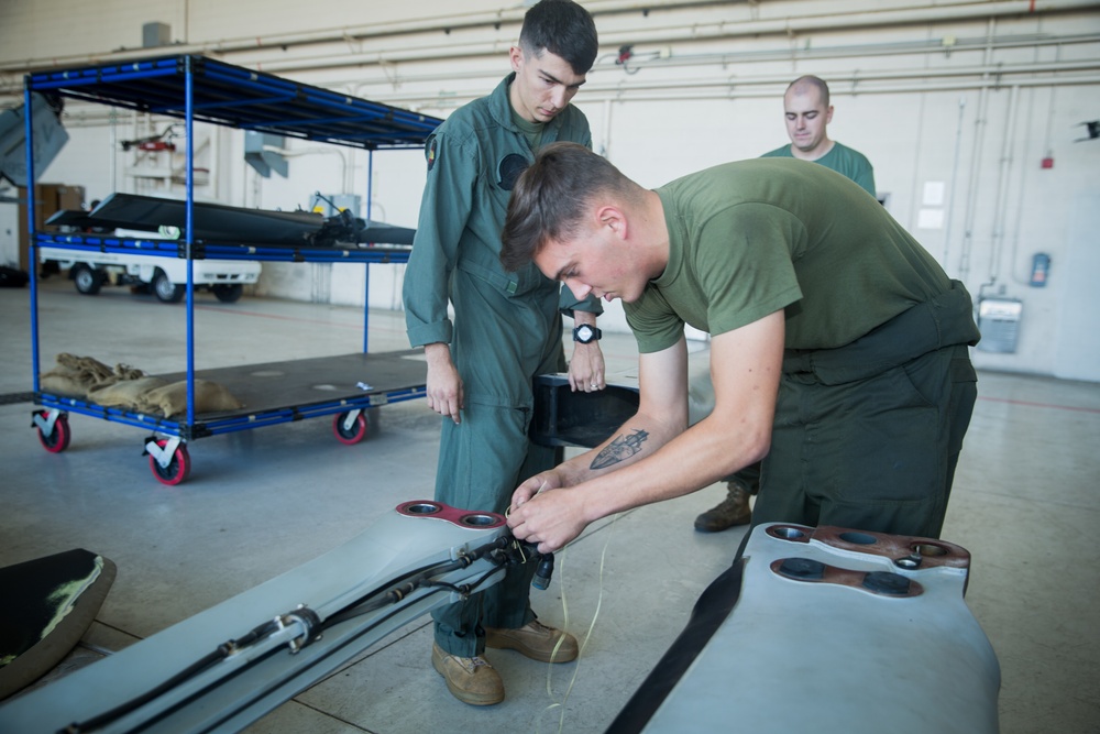 Marines with HMLA 267 maintain AH-1Z Viper Attack Helicopters