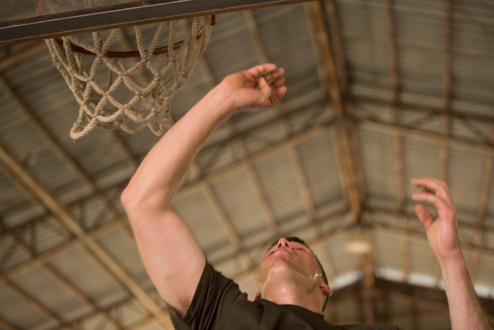 Service members and Barangay Pablicion Uno play basketball during KAMANDAG 2