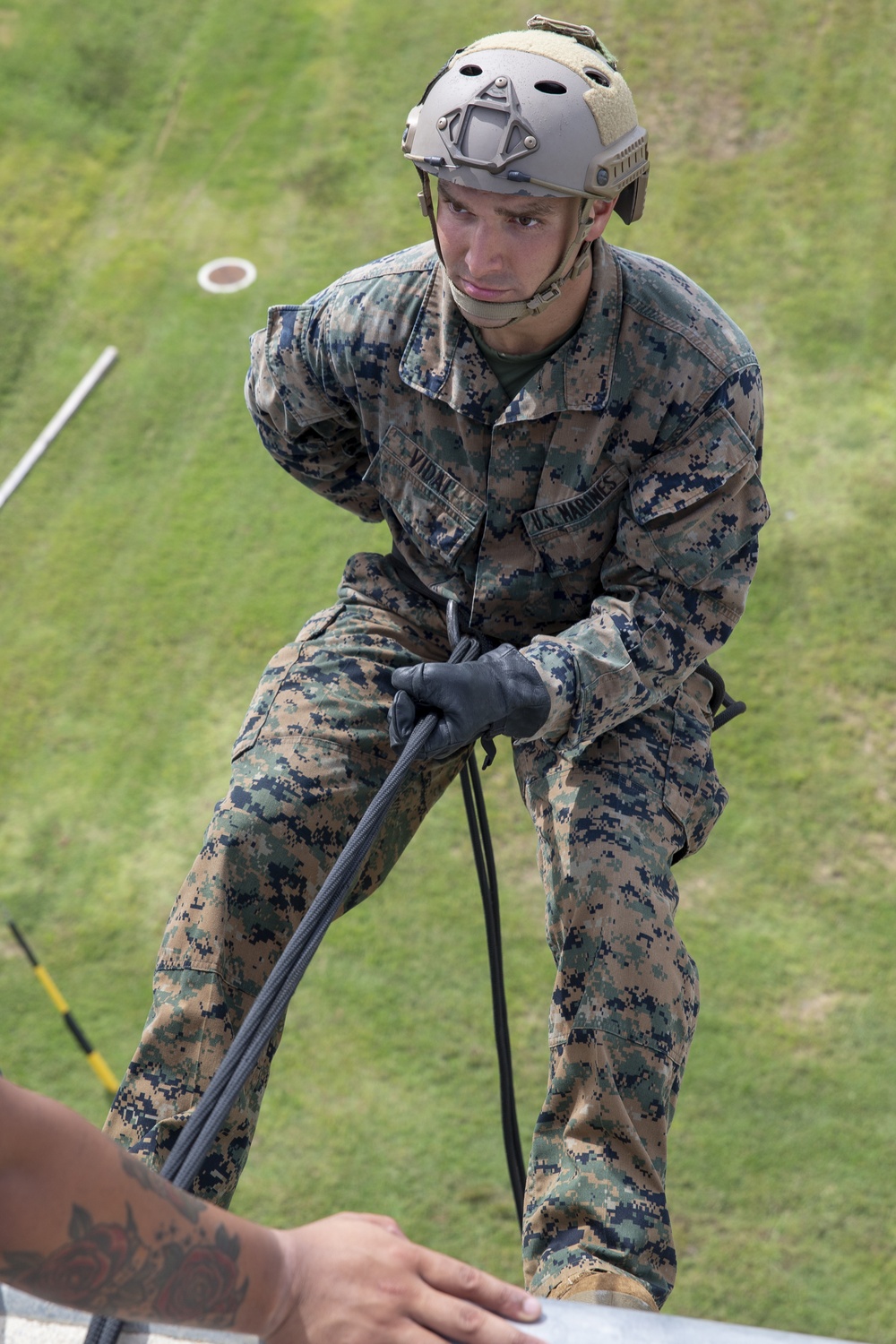 Helicopter rope suspension techniques training held at Camp Schwab rappel tower