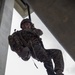 Helicopter rope suspension techniques training held at Camp Schwab rappel tower