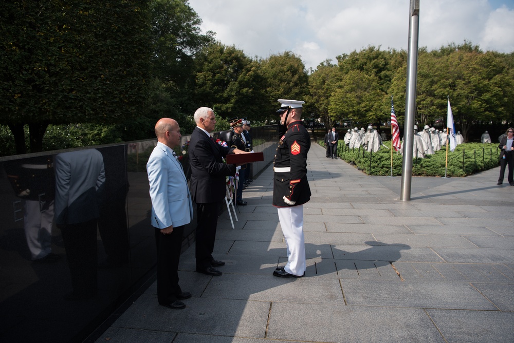 The Vice President, Secretary of the Interior and Deputy Secretary of Defense participate in a flag presentation ceremony