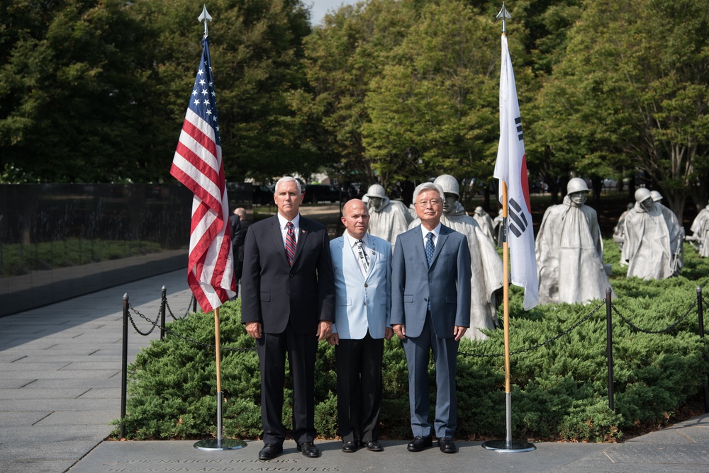 The Vice President, Secretary of the Interior and Deputy Secretary of Defense participate in a flag presentation ceremony