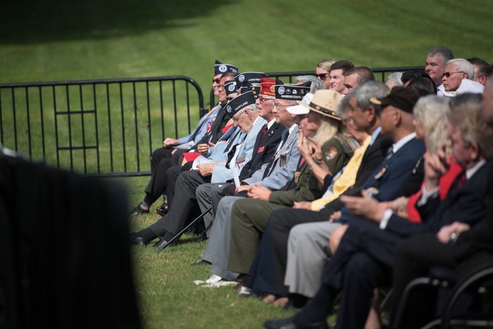 The Vice President, Secretary of the Interior and Deputy Secretary of Defense participate in a flag presentation ceremony