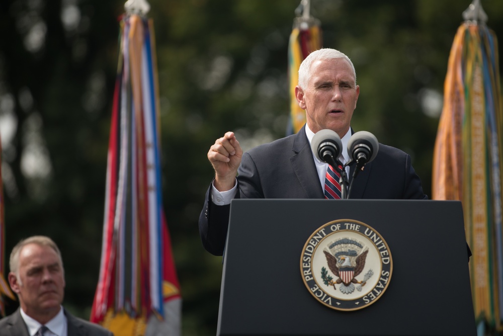 The Vice President, Secretary of the Interior and Deputy Secretary of Defense participate in a flag presentation ceremony