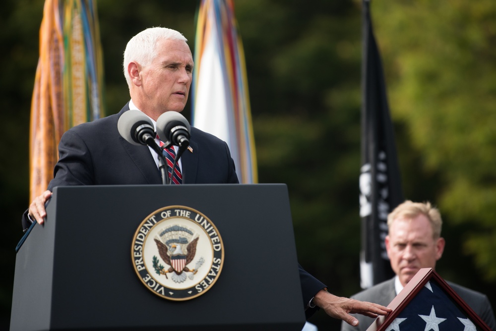 The Vice President, Secretary of the Interior and Deputy Secretary of Defense participate in a flag presentation ceremony