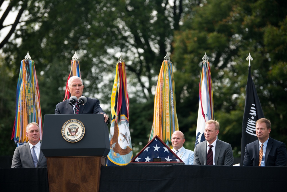 The Vice President, Secretary of the Interior and Deputy Secretary of Defense participate in a flag presentation ceremony