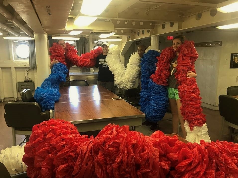 Volunteers fabricate a giant lei to hang on the USS Wisconsin