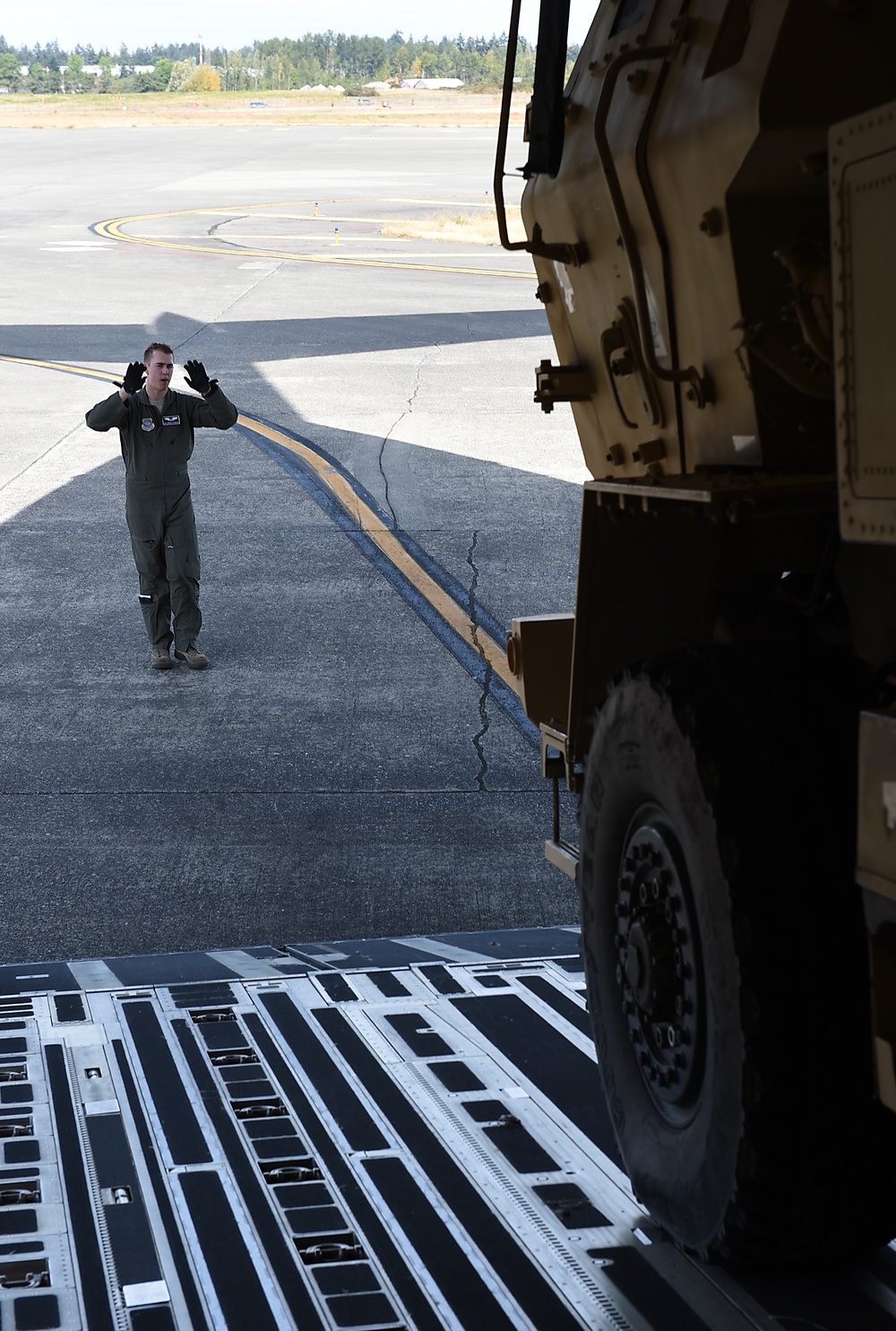 McChord loadmaster guides HIMAR onto C-17
