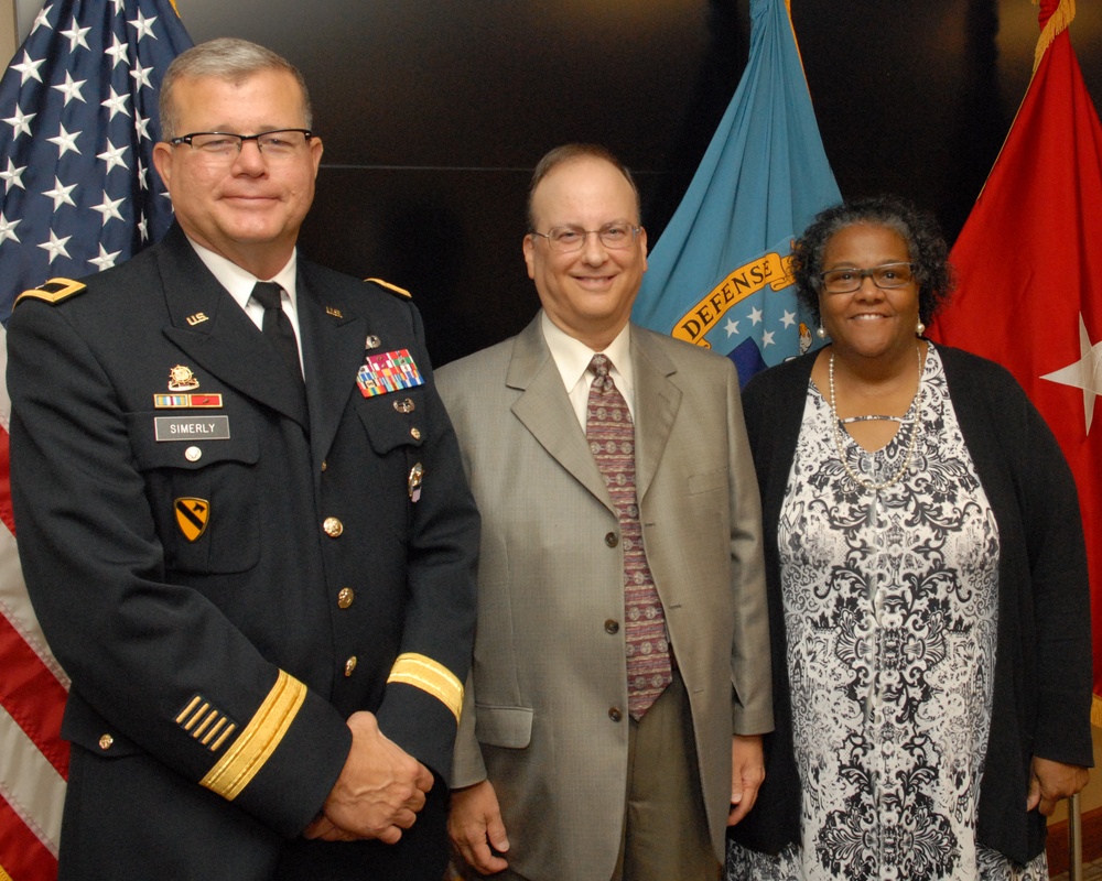 Anita Parker (right) and Philip DiBabbo (center) pose with DLA Troop Support Commander Army Brig. Gen. Mark Simerly (left) after being recognized for their service during a retirement ceremony Sept. 26 in Philadelphia.