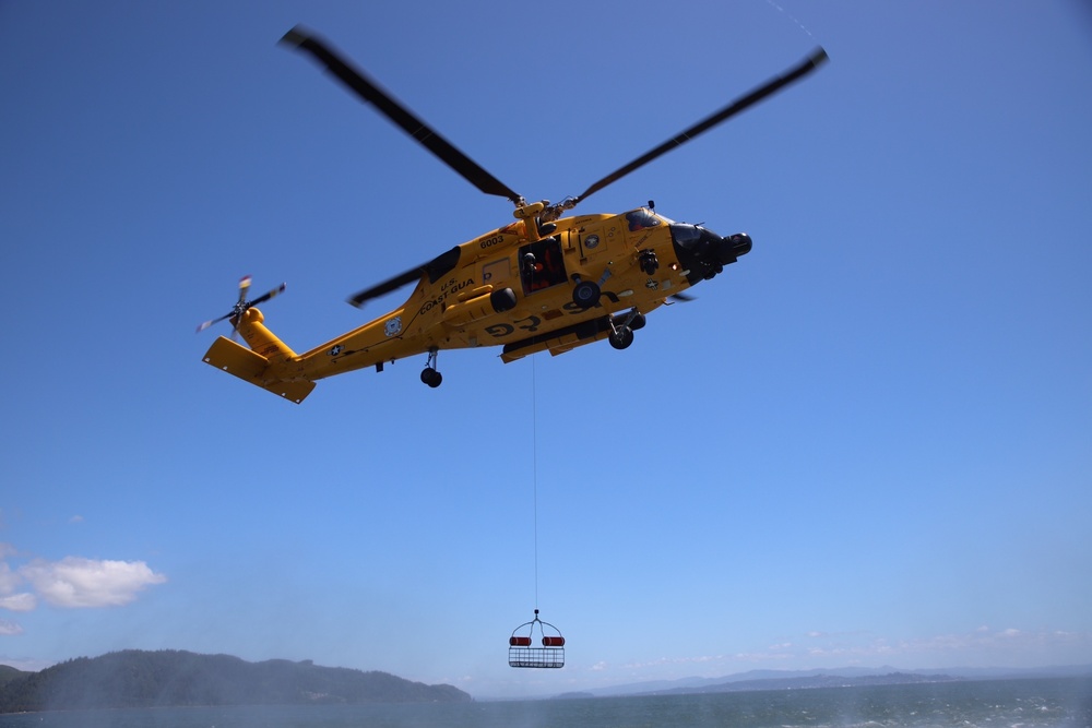 Sector Columbia River aircrew lowers rescue basket