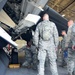 Airmen examine the operations of an F-22 Raptor munitons hull