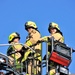 Firefighters demonstrate evacuation and rescue procedures