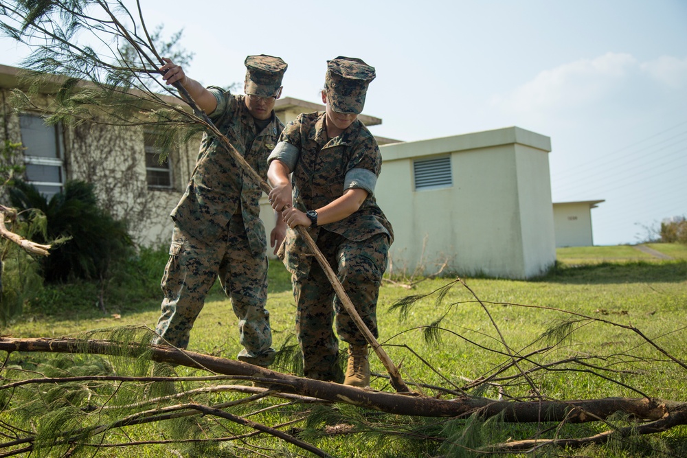 Service members clean up after Typhoon Trami