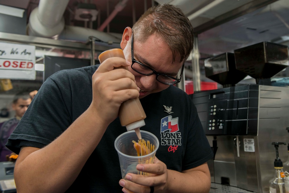 Sailor Prepares Coffee Aboard GHWB