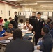 Sailors and Civilians Race Calculator Robots With Baltimore NJROTC