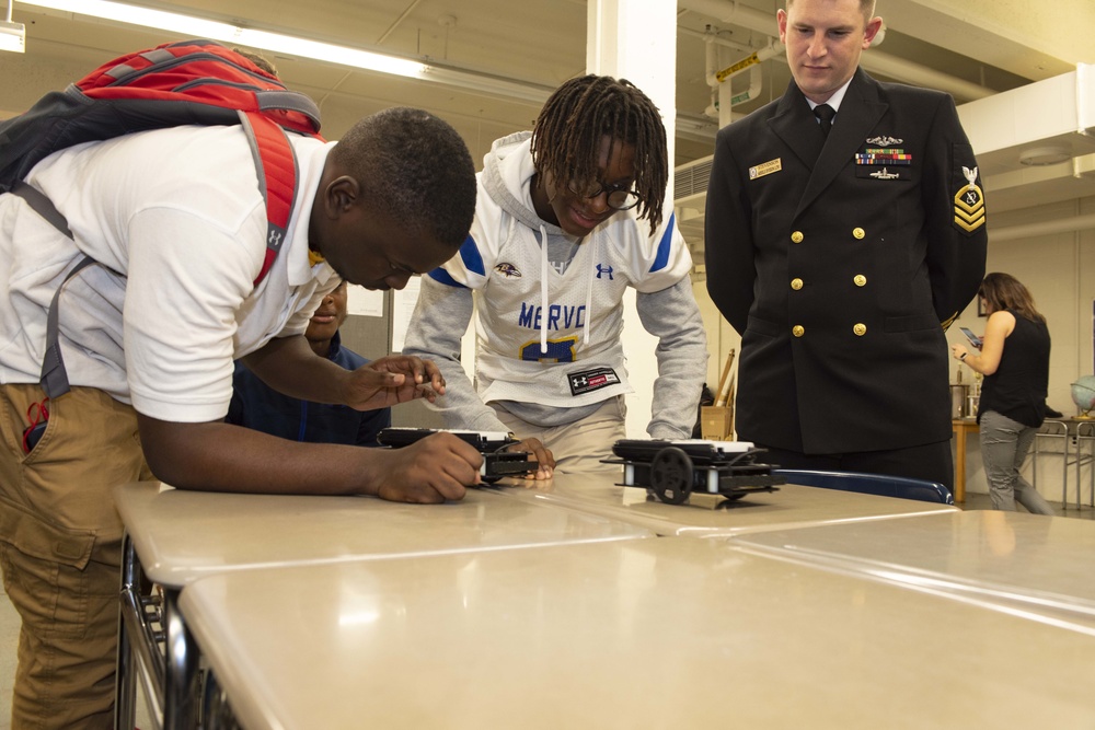 Sailors and Civilians Race Calculator Robots With Baltimore NJROTC