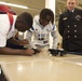Sailors and Civilians Race Calculator Robots With Baltimore NJROTC