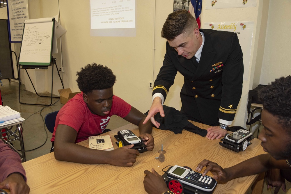 Sailors and Civilians Race Calculator Robots With Baltimore NJROTC