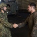 U.S. and Japanese service members shake hands after successfully completing a training exercise for KAMANDAG 2