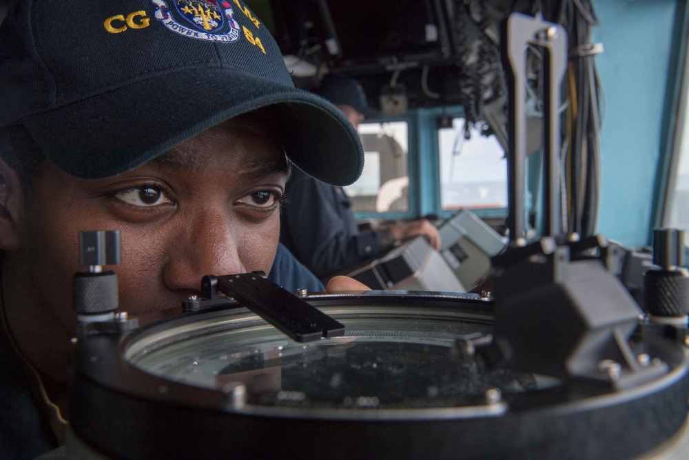 Lt. J.G. Anthony Williams, from Houston, looks through a bearing circle on the bridge of the Ticonderoga-class guided-missile cruiser USS Antietam (CG 54) during an underway replenishment (UNREP) with fleet replenishment oiler USNS Tippecanoe (T-AO 199)