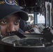 Lt. J.G. Anthony Williams, from Houston, looks through a bearing circle on the bridge of the Ticonderoga-class guided-missile cruiser USS Antietam (CG 54) during an underway replenishment (UNREP) with fleet replenishment oiler USNS Tippecanoe (T-AO 199)