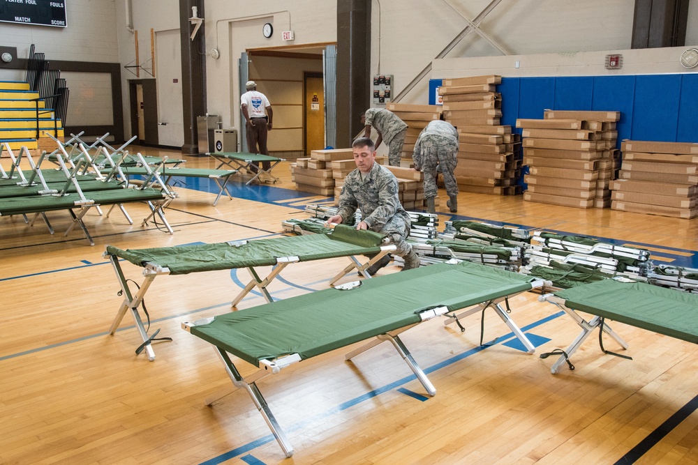 Setting up cots for Hurricane Michael evacuees