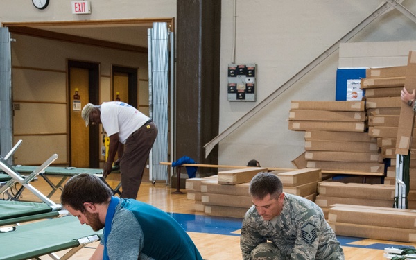 Setting up cots for Hurricane Michael evacuees