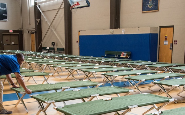 Setting up cots for Hurricane Michael evacuees