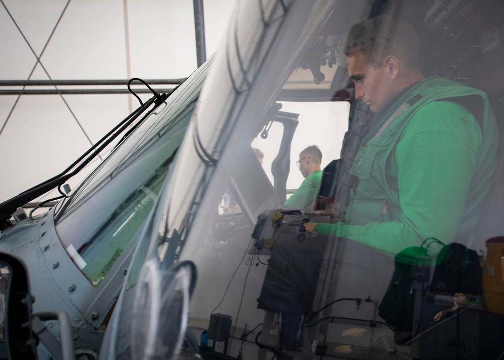 Sailor Conducts Maintinence on MH-60S assigned to USNS Comfort