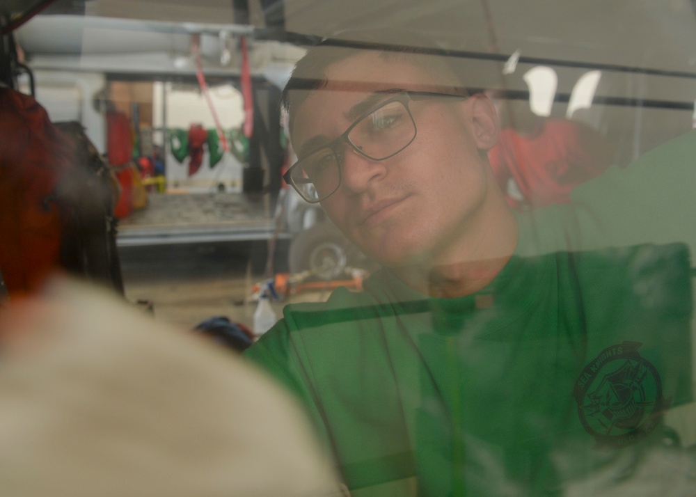 Sailor Conducts Maintinence on MH-60S assigned to USNS Comfort