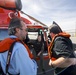 Reporters receive safety brief before boarding an MH-65 Dolphin helicopter