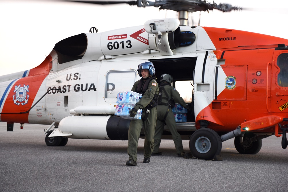 Coast Guard helicopter crew delivers supplies in Panama City, Fla.