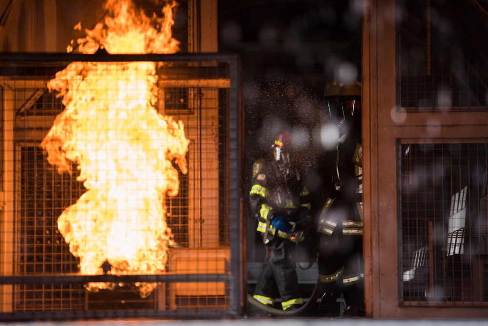 U.S. and NATO firefighters forge through the flames