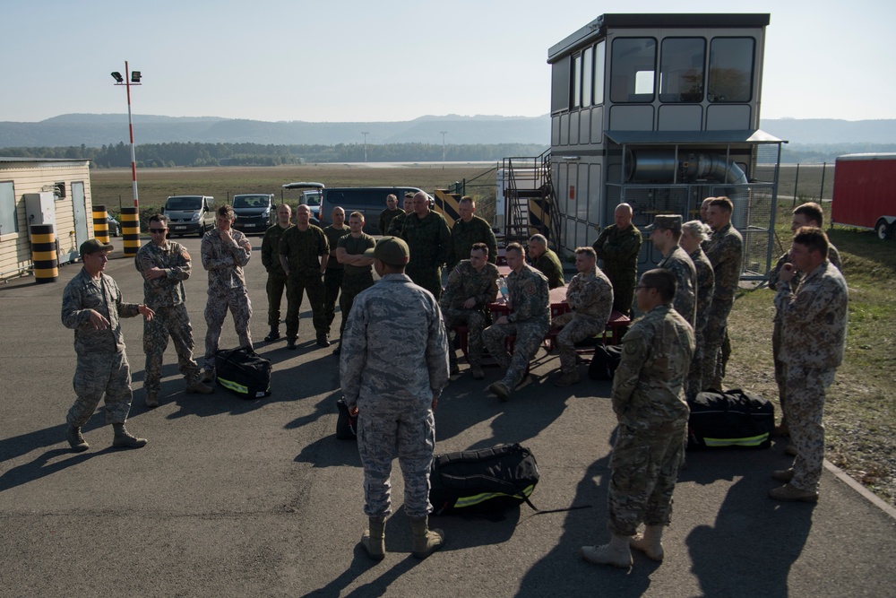 U.S. and NATO firefighters forge through the flames