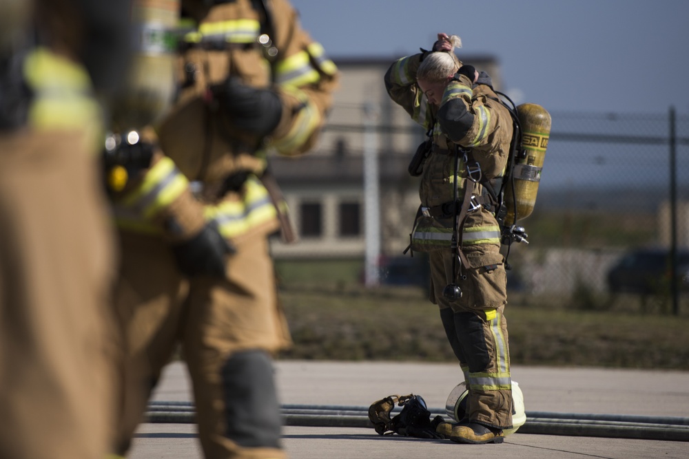 U.S. and NATO firefighters forge through the flames