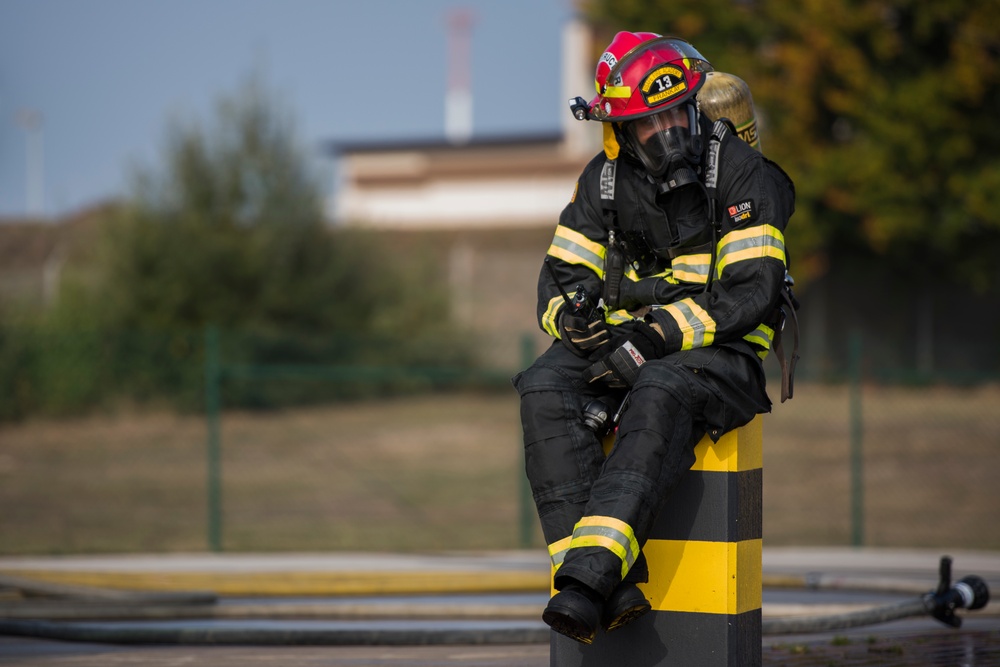 U.S. and NATO firefighters forge through the flames