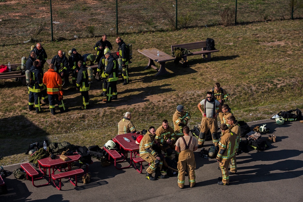 U.S. and NATO firefighters forge through the flames