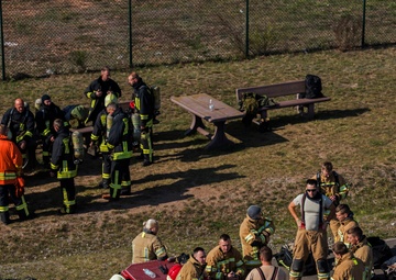 U.S. and NATO firefighters forge through the flames