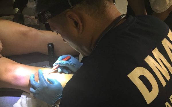 NDMS Responder Cares for Wounded Patient