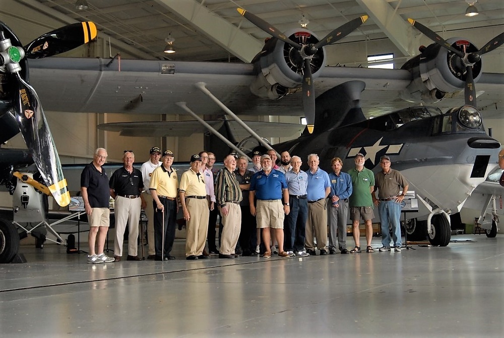 Naval Museum's volunteer corps in front of a PBY-5A