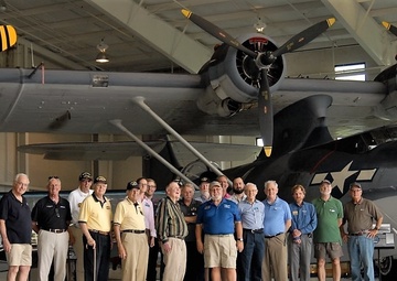 Naval Museum's volunteer corps in front of a PBY-5A