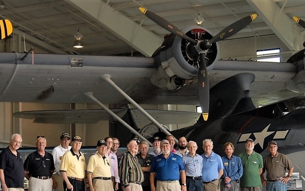 Naval Museum's volunteer corps in front of a PBY-5A