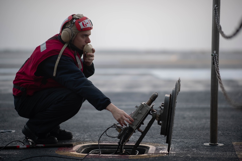 Sailor operates weapons elevator