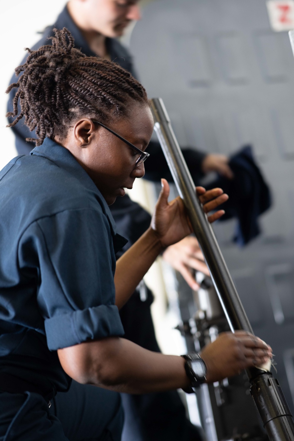 Sailors maintain machine guns aboard USS John C. Stennis