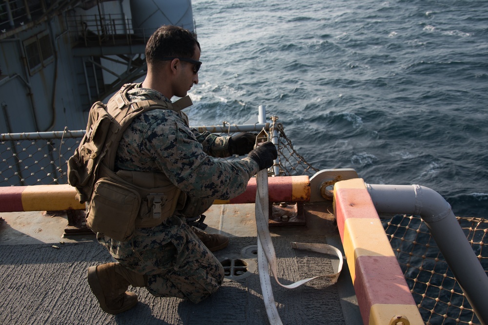 Weapons Company Marines fire machine guns aboard the Wasp