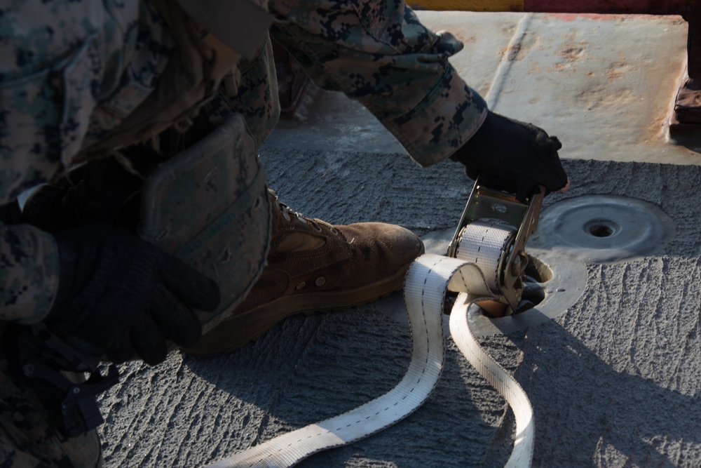 Weapons Company Marines fire machine guns aboard the Wasp