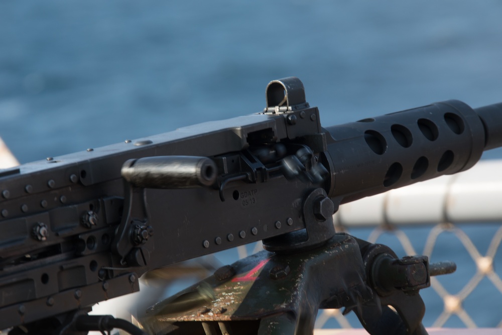 Weapons Company Marines fire machine guns aboard the Wasp