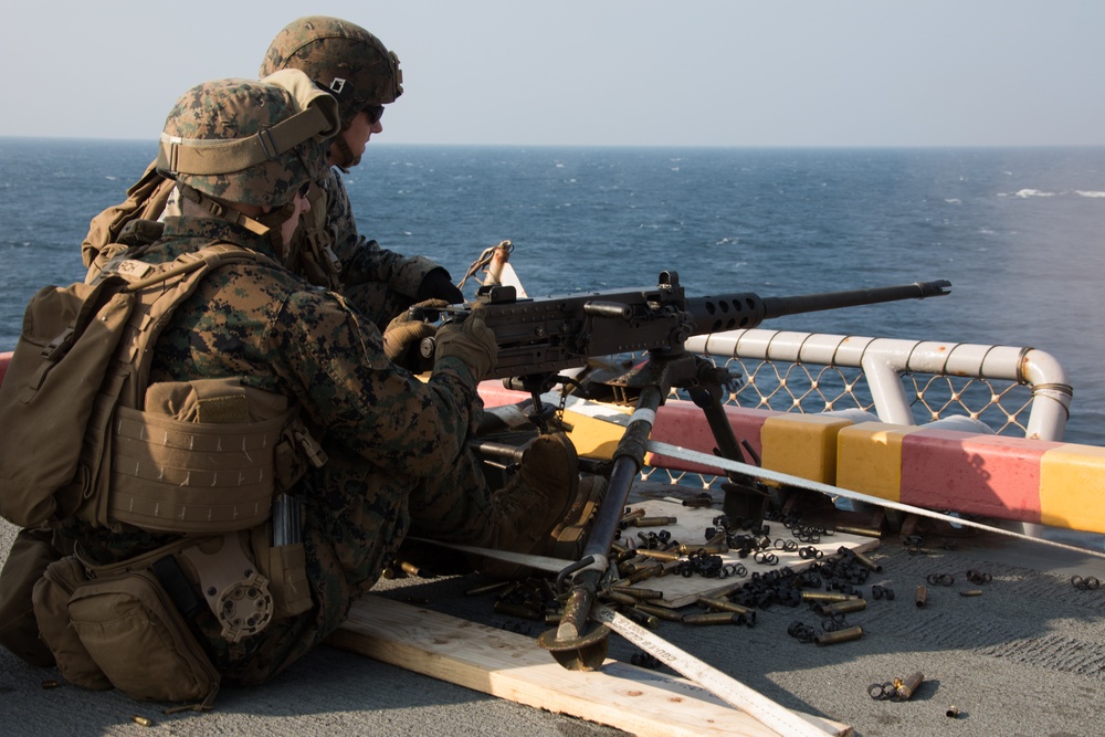Weapons Company Marines fire machine guns aboard the Wasp