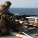 Weapons Company Marines fire machine guns aboard the Wasp